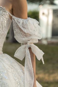 the back of a woman's wedding dress with sequins