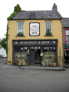 a store front with lots of items on display in it's windows and doors