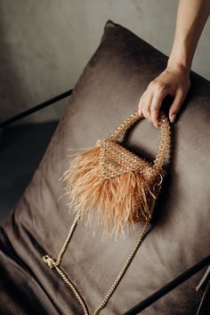 Elegant Beaded Handbag with Feather Fringe Our bag's exquisite crystal beads create a mesmerizing shimmer that catches the light from every angle, adding a touch of glamour to your ensemble. A sturdy, beaded handle ensures easy carrying. Includes a detachable gold chain strap for versatile wear as a shoulder bag or crossbody. The top of the bag features a sturdy and convenient snap closure, ensuring that your belongings remain safe and protected. Each bag is meticulously crafted by skilled artis Feather Fringe, Fringe Handbags, Crystal Bags, Statement Bag, Beaded Handbag, Ostrich Feather, Evening Purse, Ostrich Feathers, Champagne Color