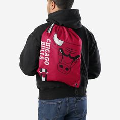 Whether you're going to work, class, or the gym, make sure you always put the team on your back. Literally. Store your stuff and show off your team spirit with this Chicago Bulls Big Logo Drawstring Backpack. Features Easy adjustable cinch top cords to make storing your stuff quick and easy Screen printed design so everyone knows who you're rooting for on gameday Details Dimensions: Approximately 18” x 14” Volume: Approximately 4L Officially licensed Imported Sporty School Backpack With Functional Drawstring, Sporty Drawstring Backpack For Outdoor Activities, Sports Nylon Gym Bag With Drawstring, Casual Nylon Drawstring Bag For Sports, Sports Gym Bag In Nylon With Drawstring, Casual Nylon Drawstring Sports Bag, Casual Black Gym Bag For Sports Events, Sporty Nylon Drawstring Bag For Sports, Sporty Drawstring Backpack For The Gym