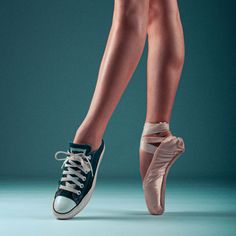 a woman's legs and feet with ballet shoes on, against a blue background