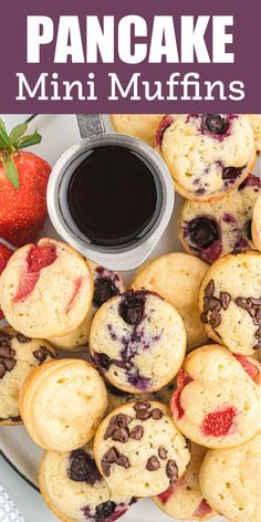 a plate with mini muffins topped with blueberries and strawberries