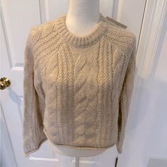 a sweater on a mannequin in front of a door