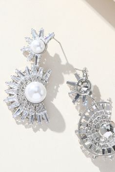 Elevate your elegance with our Floral Rhinestone Pearl Earrings. These exquisite earrings feature a captivating combination of floral motifs, sparkling rhinestones, and lustrous pearls, creating a timeless and charming accessory. Crafted with high-quality materials, they not only enhance your allure but also add a touch of sophistication to any look. Perfect for weddings, cocktail parties, or a romantic night out, these earrings are the ideal choice to make a statement and shine with grace. Romantic Night, Cocktail Parties, Elegant Accessories, Silver Drop Earrings, Floral Motifs, Rhinestone Earrings, Pearl Drop Earrings, Elegant Earrings, Pearl Drop