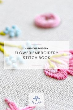 the embroidery flower embroidery stitch book is open and has pink, blue, yellow, and white flowers on it