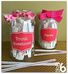 two jars with clothes pins in them and a pink bow on the top one is labeled truth questions