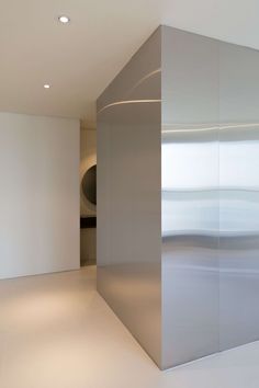 an empty room with white walls and floor