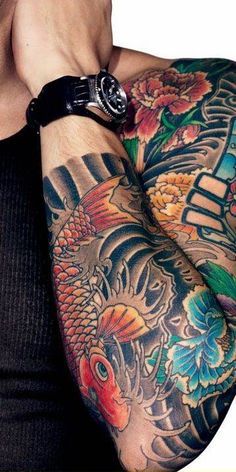 a man with many tattoos on his arm