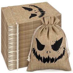 two burlap bags with faces on them, one is brown and the other is black