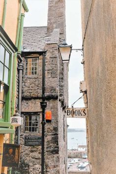 an old stone building with a sign that reads books