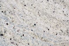 an image of white marble with black dots