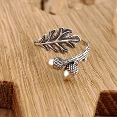 Beautiful sterling silver leaf and acorn adjustable ring. This beautiful sterling silver adjustable oak leaf and acorn ring represents strength and longevity, and can remind us of our humble beginnings. The life-like details - from the hatchmarks on the shell to the texture on the branch band - make this ring a special find, especially in the autumn season. Oak trees start life as an acorn, and can take centuries to become the mighty oak tree of legendary status.   As with all our adjustable rin Acorn Ring, Witch Fairy, Silversmithing Jewelry, Fall Nature, Mighty Oaks, Wiccan Witch, Oak Trees, Autumn Nature, Oak Leaf