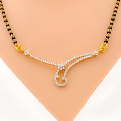 Elevate your look with our Dainty Curved Diamond Mangal Sutra. Crafted in 18k yellow gold with a 0.54ct round brilliant cut diamond pendant, this piece exudes elegance and sophistication. The black bead chain is made of 22k gold and measures 18 inches in length with a drop length of 0.5 inches. With an item weight of 2.5 grams, this piece is perfect for everyday wear. PRODUCT DETAILS Diamond Pendant Gold Purity(karat): 18k Item Weight(grams): 2.5 Item Finish: Yellow Gold Stone: Diamond Diamond W Elegant Black Diamond Necklace Gift, Black Diamond Necklace With Single Cut Diamonds As Gift, Black Diamond Necklaces, Anniversary Necklace With Black Diamonds, Gold Jewelry With Black Diamonds, Elegant Black Round Diamond Necklace, Dazzling Black Diamond Jewelry, Wedding Jewelry With Black Diamonds In Yellow Gold, Yellow Gold Jewelry With Black Diamonds For Wedding