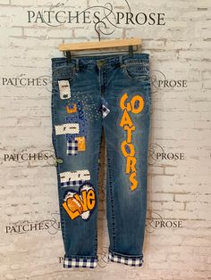 Show Your Team Spirit with Wearable Jeans Art! Made-to-order from Lee Extreme Motion Slim Straight jeans in your size and color of choice. (Available sizes: waist from 29"-42"; inseam from 30"-36". Options vary depending on color preference.) Or send me your favorite jeans to update, even if they are worn through or heavily distressed. You will help design your jeans with fabrics you prefer (polka dots, stripes, bright colors, geometrics, lace, whatever you love!) and we will work together to de Spirit Jeans Ideas, College Jeans, Flared Jeans 70s, Jeans Art, Sashiko Stitching, Dark Wash Flare Jeans, Florida Gator, What Team, Custom Jeans