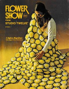 a woman sitting on the ground covered in yellow flowers