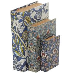 three blue and white books with floral designs on the front, one is folded in half