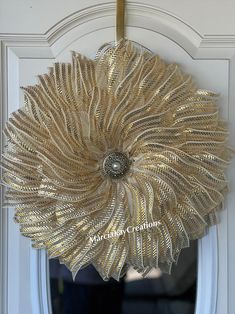 a gold flower hanging from the side of a door