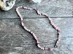 Ombre pink gemstone candy necklace. This lovely, delicate gemstone necklace contains gemstones in shades of pastel pink and purple with occasional hints of golden yellow. Peruvian opal, moonstone, lavender moonstone, citrine, amethyst, freshwater pearl, morganite, agate, lavender opal, rhodochrosite, and spinel. Finished with a sterling silver clasp. The gems in this necklace are a more delicate 5-6mm size, and are individually hand knotted onto rose colored silk. Necklace is about 18.25 inches Delicate Pink Gemstone Crystal Necklace, Dainty Single Strand Pink Jewelry, Adjustable Pink Gemstone Beaded Necklace, Adjustable Pink Gemstone Beaded Necklaces, Pink Bohemian Crystal Necklace With Gemstone Beads, Adjustable Pink Crystal Necklace With Natural Stones, Adjustable Pink Crystal Necklaces With Natural Stones, Pink Bohemian Jewelry With Faceted Beads, Bohemian Pink Crystal Necklace With Gemstone Beads