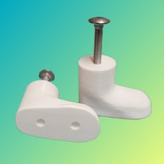 two white toilet paper holders with screws on them