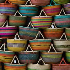 many baskets are stacked together in different colors