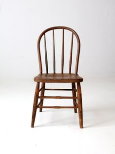 a wooden chair sitting on top of a white floor