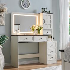 a white desk with drawers and a mirror on it next to a bed in a room