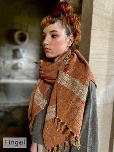 a woman with red hair wearing a scarf