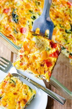 a slice of vegetable quiche on a plate with a fork and serving utensil