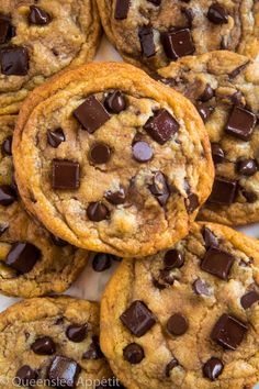 several chocolate chip cookies on a white plate