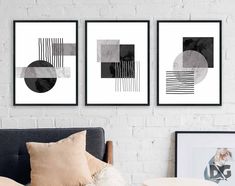 three black and white art prints hanging on a wall above a couch in a living room