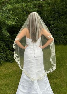 the back of a bride's wedding dress and veil