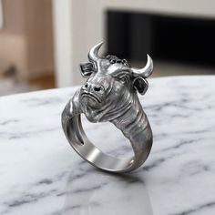 This Taurus Bull Head with Horns Ring is crafted from high-quality 925 Sterling Silver, making it a bold and striking piece of jewelry. Inspired by the power and strength of the Taurus symbol, this ring captures the essence of the zodiac sign with its detailed bull head design and prominent horns. Perfect for men who appreciate statement pieces or want to showcase their zodiac pride, this silver ring fits any occasion, whether casual or formal. The comfortable fit and durable material ensure lon Taurus Symbol, Taurus Bull, Horn Ring, Bull Horns, Bull Head, Biker Jewelry, Viking Ring, Masonic Ring, Retro Ring