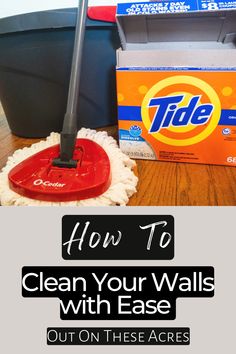 a cleaning mop on top of a wooden floor next to a pile of boxes