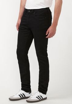 Step into style with the Skinny Max Men's Jeans in Midnight Wax. These striking jeans feature a unique crinkled dark denim finish, adding both texture and trendy attitude to your look. They are designed with a regular rise and a skinny fit that follows the leg to the hem, delivering a modern silhouette perfect for any fashion-forward guy. The classic five-pocket styling, complemented by a zip fly and a distinctive Buffalo rivet at the rear pocket, makes these jeans a timeless addition to your wa Urban Black Slim Fit Jeans, Edgy Black Slim Fit Jeans, Black Slim Denim Bottoms, Black Slim Fit Jeans With Standard Cut Leg, Black Urban Jeans, Black Slim Bottoms With Five Pockets, Black Slim Fit Jeans, Slim Legs, Black Coat