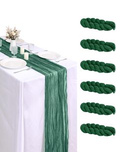 the table is set with plates and napkins on it, along with green cords