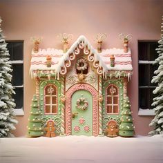 a gingerbread house decorated for christmas with snow on the ground and trees in front