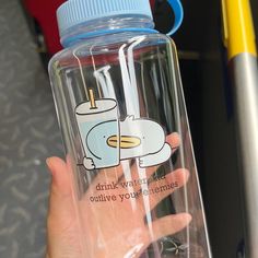 a person holding a water bottle with a cartoon character on it