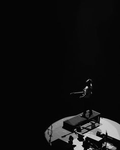 a person standing on top of a table in the dark