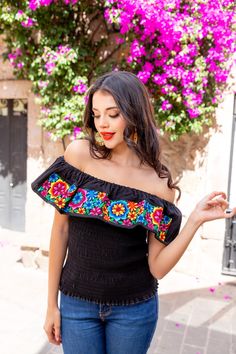 This Beautiful Daisy Embroidered Crop Top is the perfect Top to add to your wardrobe. It's made out of cotton, has an elastic waist and is full of vibrant embroidered florals. This Top is made with love by Mexican Artisans in Guanajuato, Mexico. Black Summer Tops With Intricate Embroidery, Black Tops With Intricate Embroidery For Summer, Black Embroidered Tops For Summer, Multicolor Embroidered Sleeve Summer Tops, Fitted Top With Multicolor Geometric Embroidery, Fitted Folk Top With Embroidered Border, Fitted Folk Style Embroidered Top, Fitted Embroidered Border Top, Fitted Tops With Multicolor Embroidery For Vacation