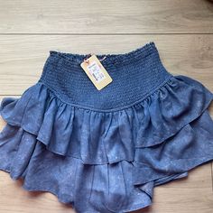 Brand New With Tags Medium Denim Color Ruffled Skirt Purchased At A Local Boutique Indigo Washed Bottoms For Spring, Casual Blue Denim Skirt With Elastic Waistband, Trendy Blue Ruffled Skirt, Summer Dark Wash Skirt, Spring Washed Denim Mini Skirt, Denim Blue Washed Skirt For Summer, Summer Blue Washed Skirt, Blue Skirt With Frayed Hem For Day Out, Denim Blue Ruffled Skirt Bottoms