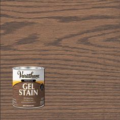 a can of walnut gel stain sitting on top of a wooden floor next to a bottle of paint