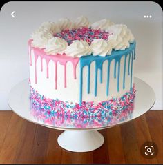 a cake with white frosting and sprinkles on it