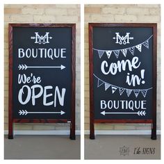 two blackboards with white writing on them and bunting flags hanging from the wall