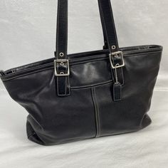 Buttery soft Coach Hampton 5246 Black Leather Large Tote Shoulder Bag measuring about 15" x 10" x 4.5" with dual Handles with a 9.5" strap drop Missing 1 grommet and a little wear on one strap, a little wrinkling of the leather on one side, very slight wear in a couple of places on the bottom, and a few small spots inside - see photos And although this might seem like a long list of what's wrong, I was just trying to be extras thorough. This is a beautiful bag with pretty slight overall wear. Or Coach Medium Leather Shoulder Bag, Classic Satchel With Snap Closure, Casual Coach Shoulder Bag With Silver-tone Hardware, Casual Coach Leather Bag, Casual Rectangular Satchel With Silver-tone Hardware, Casual Black Bag With Silver-tone Hardware, Casual Travel Bags With Silver-tone Hardware, Casual Shoulder Bag With Silver-tone Hardware For Shopping, Casual Black Coach Bag