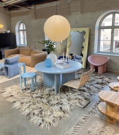 a living room filled with lots of furniture and decor on top of carpeted flooring