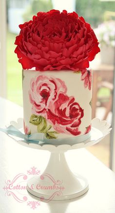 a white cake with red flowers on it