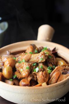 a wooden bowl filled with meat and vegetables