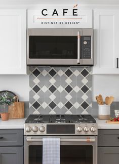 a stainless steel oven and microwave in a kitchen with white cabinets, gray counter tops