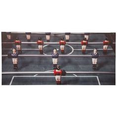 an overhead view of a foosball table soccer game with red, white and blue players