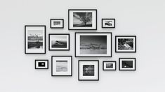 a white wall with black and white pictures hanging on it's sides, all in different frames